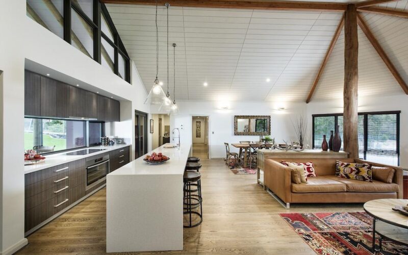 Bright open plan kitchen with wooden beams