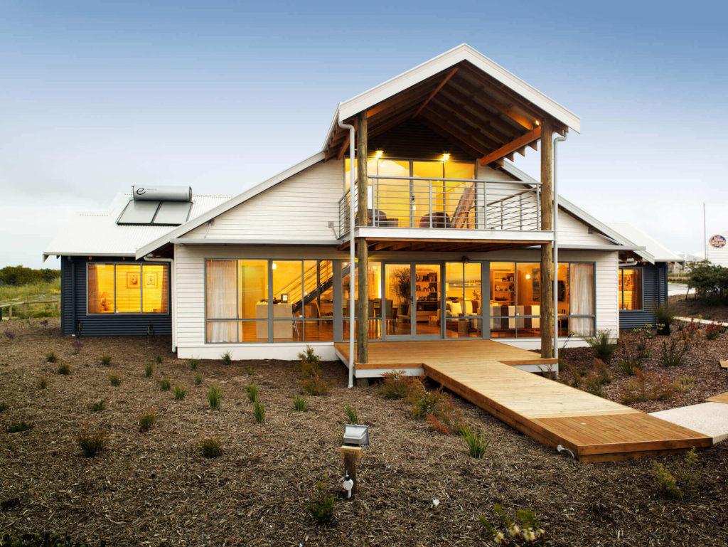 Front view of Capricorn Loft at sundown with house lights on - RuralBuilding Co.