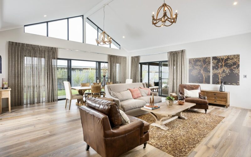 open plan living area with big windows and raked ceilings