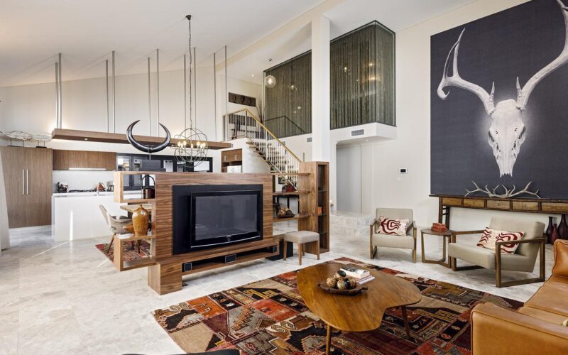 Open plan country home with leather sofa and wooden kitchen cabinets