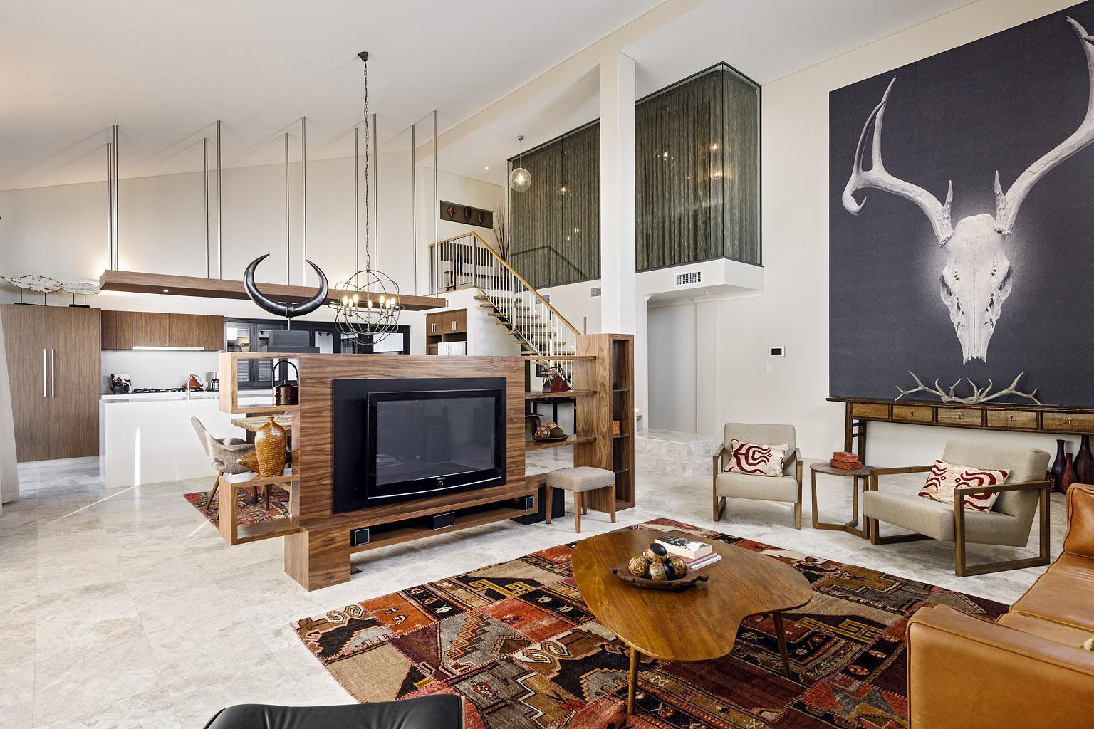 Open plan country home with leather sofa and wooden kitchen cabinets