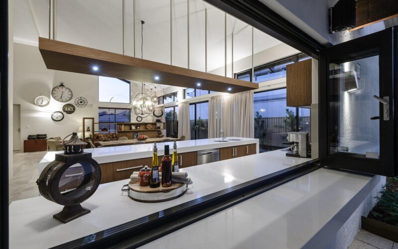 Open plan kitchen viewed through bifold windows/bar