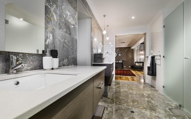 Brightly lit bathroom with dark cabinets