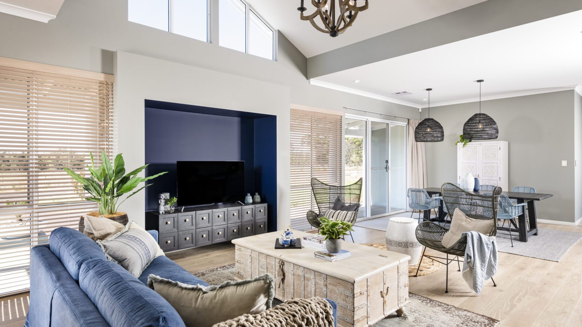 open plan living with neutral colours and high ceilings and windows