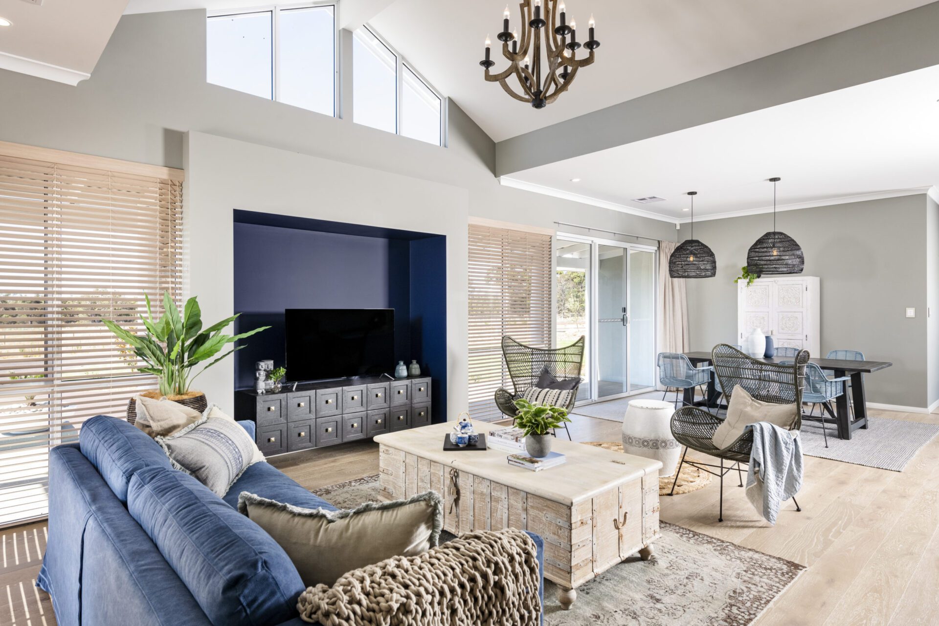 open plan living with neutral colours and high ceilings and windows