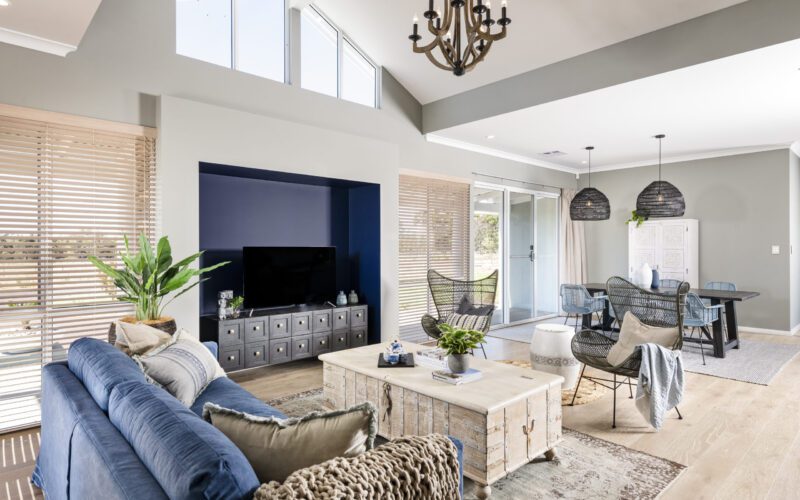 open plan living with neutral colours and high ceilings and windows