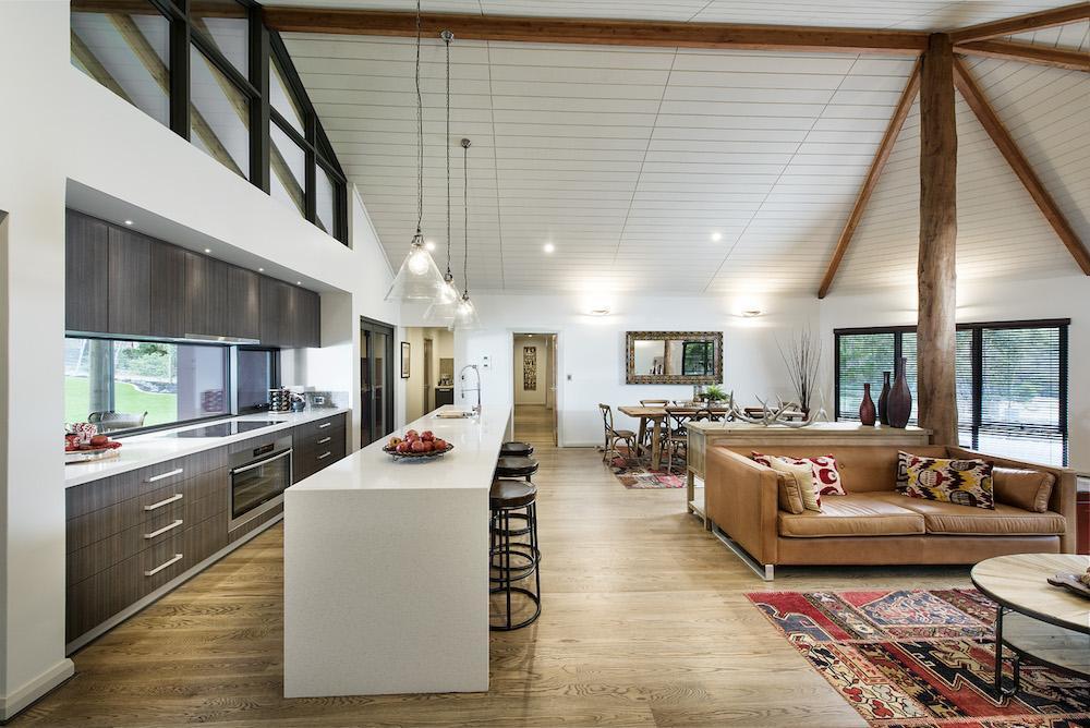 country style kitchen with overhanging lights and wooden beams