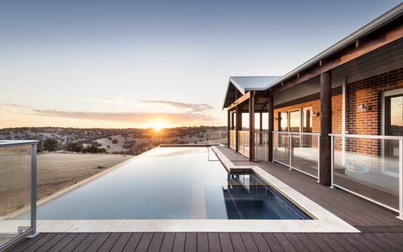 Sunset over a country house with swimming pool