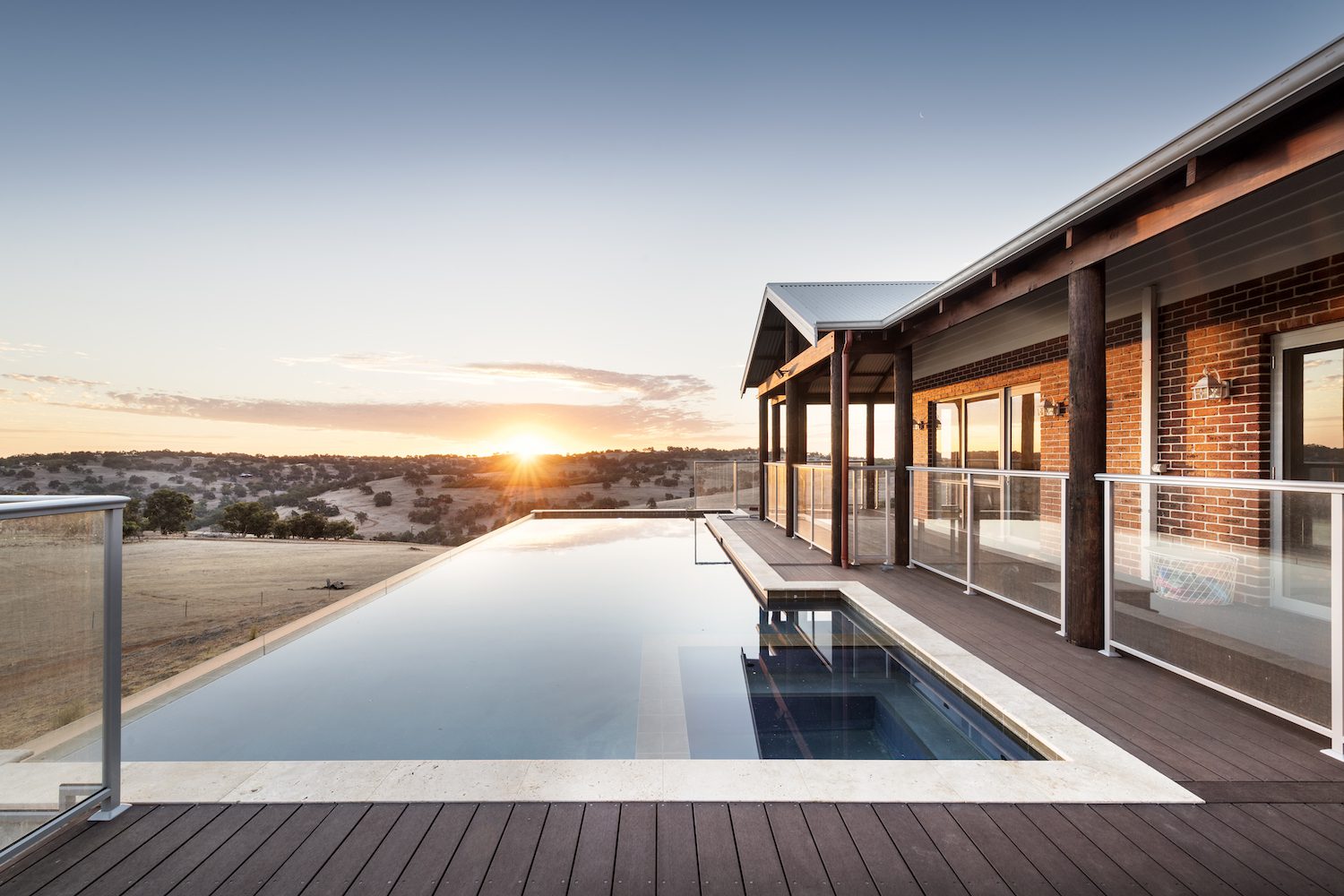 Sunset over a country house with swimming pool