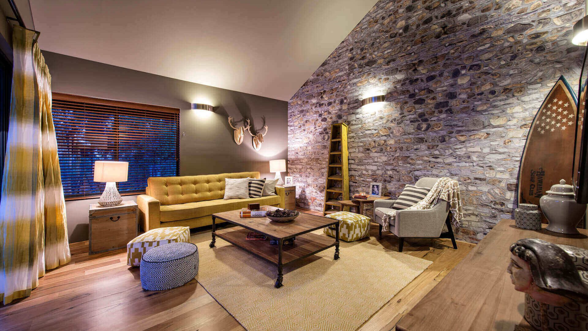 dark earthy living room with a yellow couch