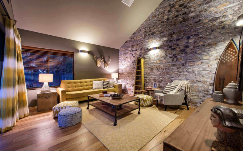 dark earthy living room with a yellow couch