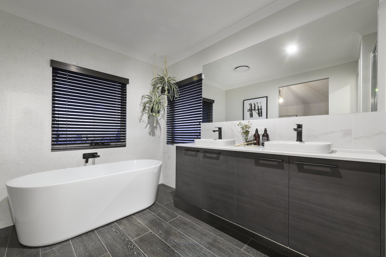 Modern bathroom with feature plant and freestanding bath