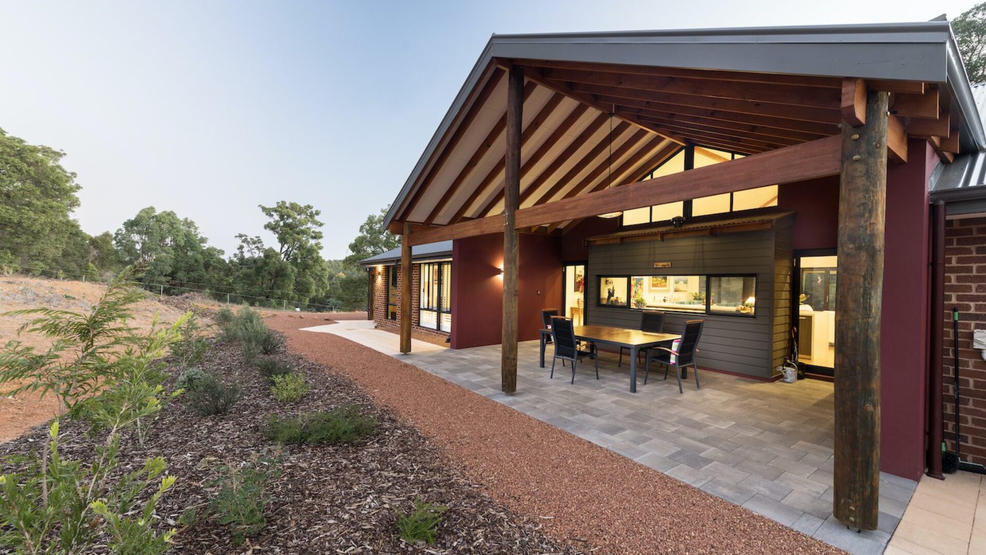 Alfresco with timber posts and gravel surrounds looking out to bushland