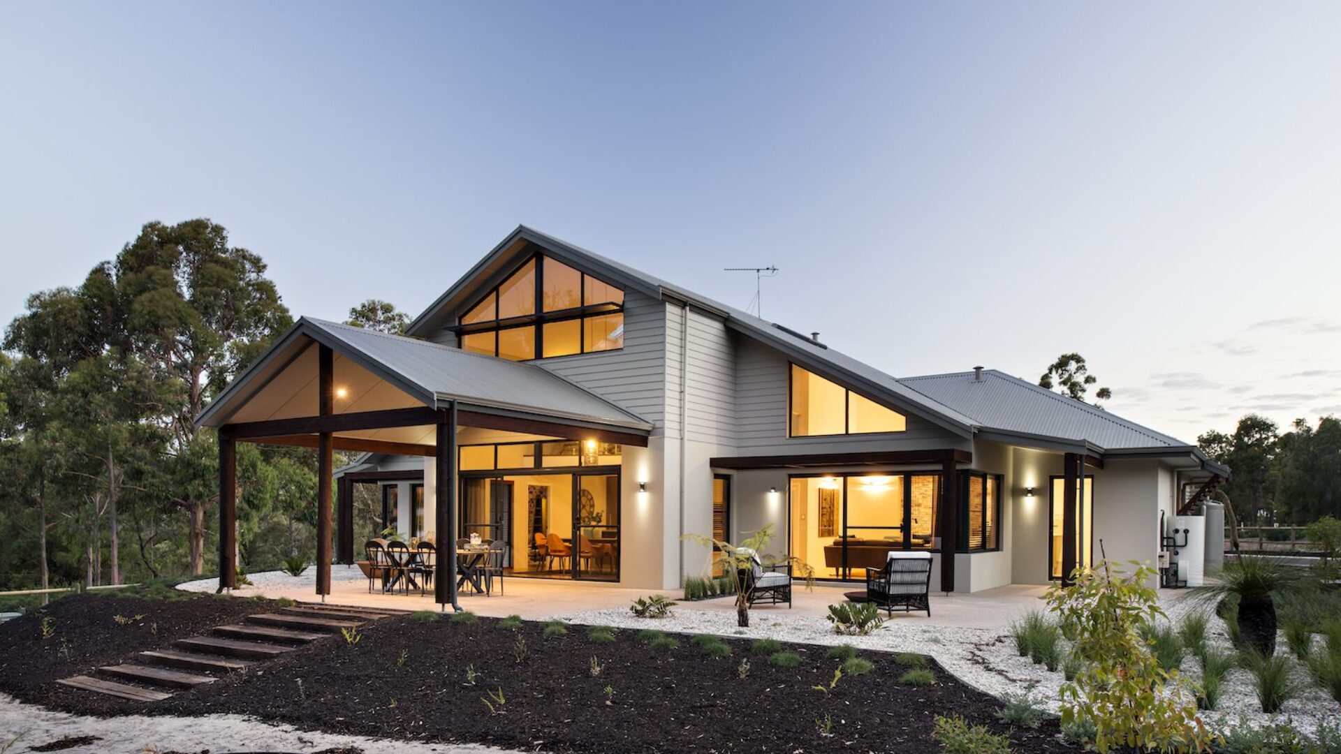 Single storey home at dusk with gable roofline and covered alfresco