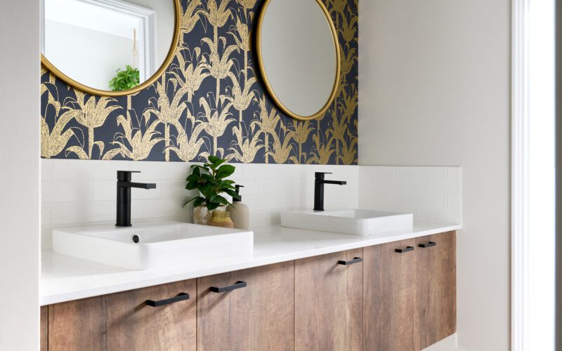 bathroom with feature wallpaper and double vanity