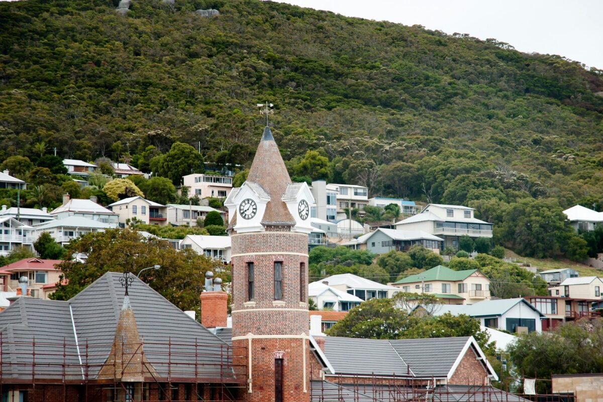 Albany’s historic town clock tower with surrounding hillside homes, captured for Albany Builders Rural Building Co.