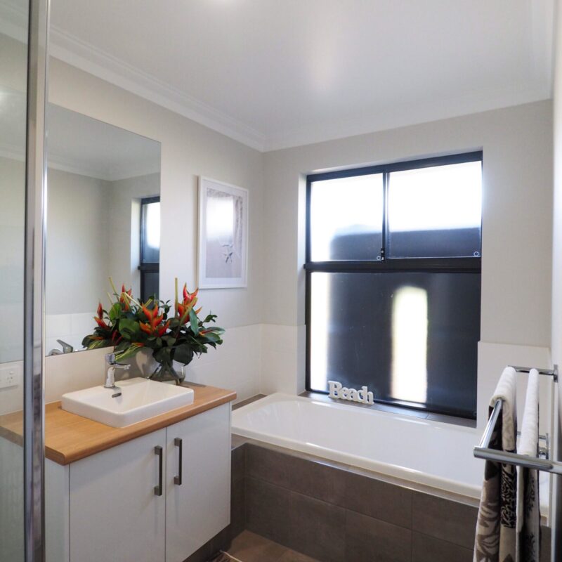 Bathroom with timber vanity, vessel basin and built in bath
