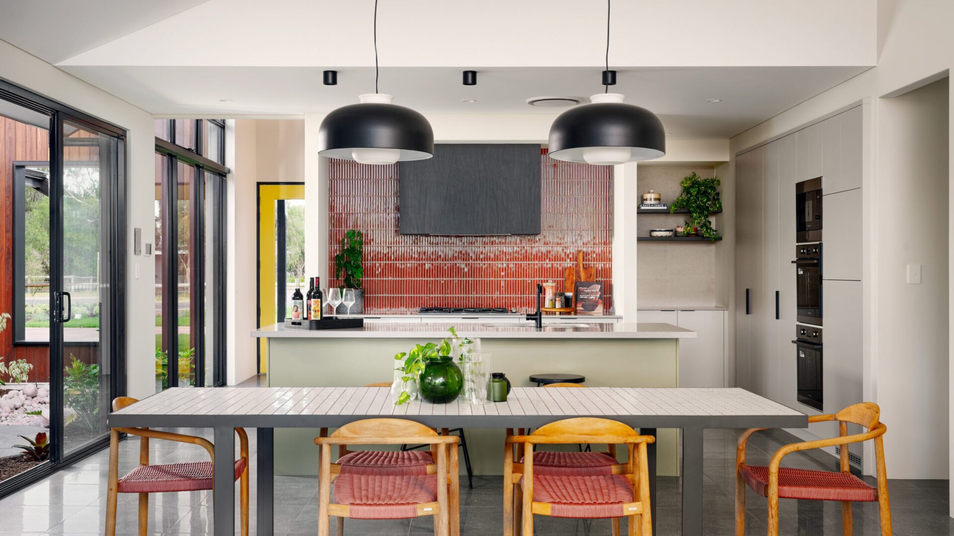 sage green kitchen cabinets and coloured splashback
