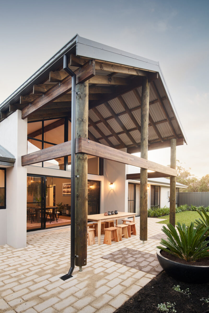 Timber posted portico entry with courtyard beyond