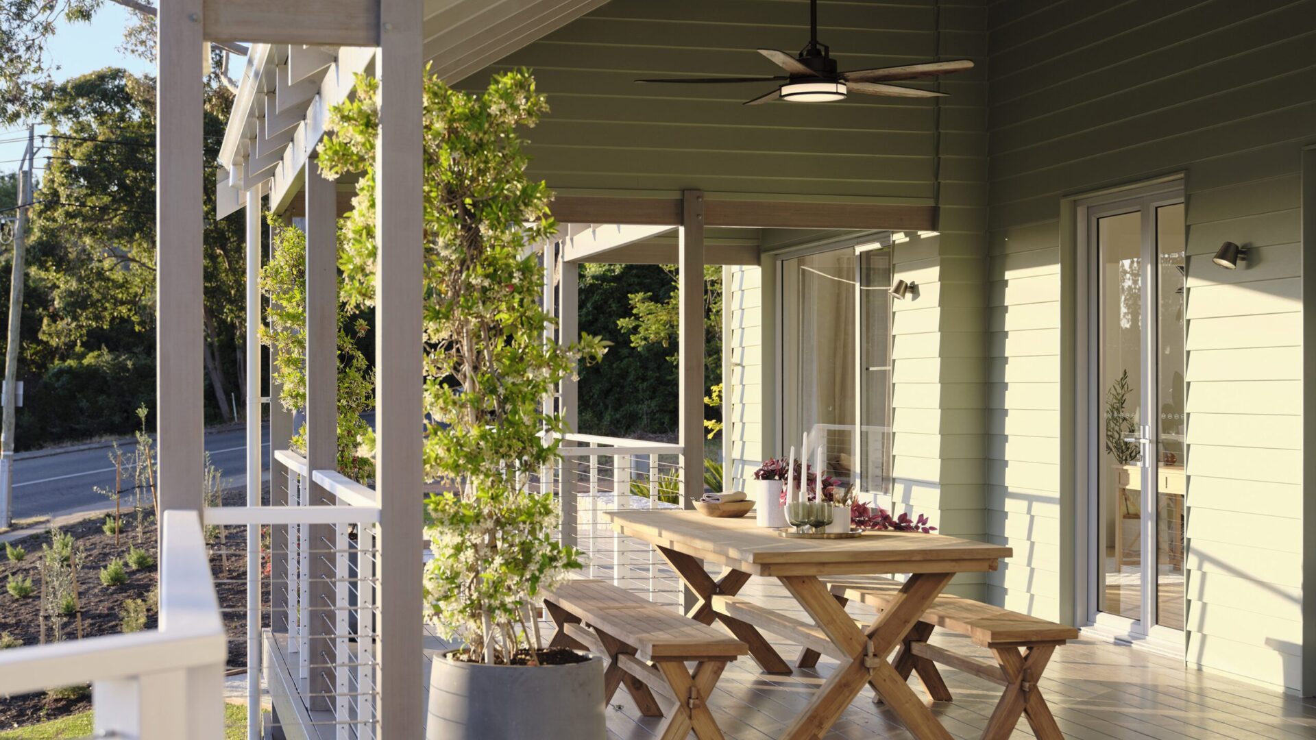 Verandah with timber picnic table, ceiling fan and cable balustrade