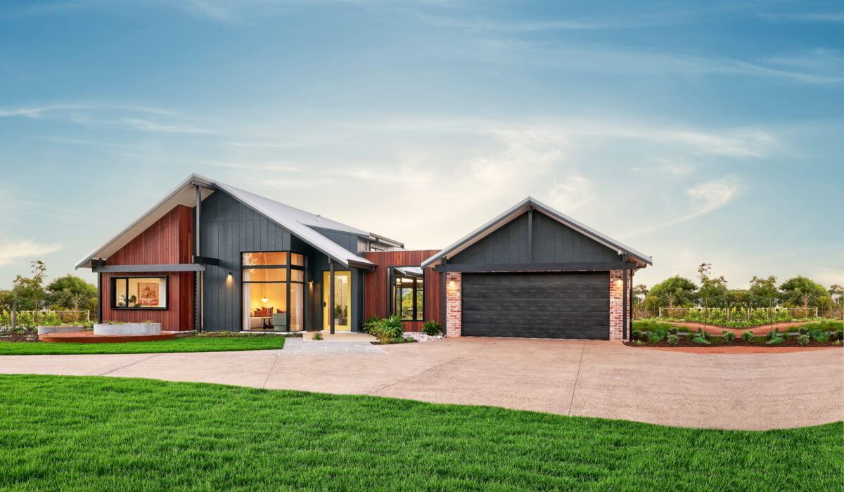 Daylight shot of the Daintree retreat country home by rural building company. With double garage and landscaped gardens