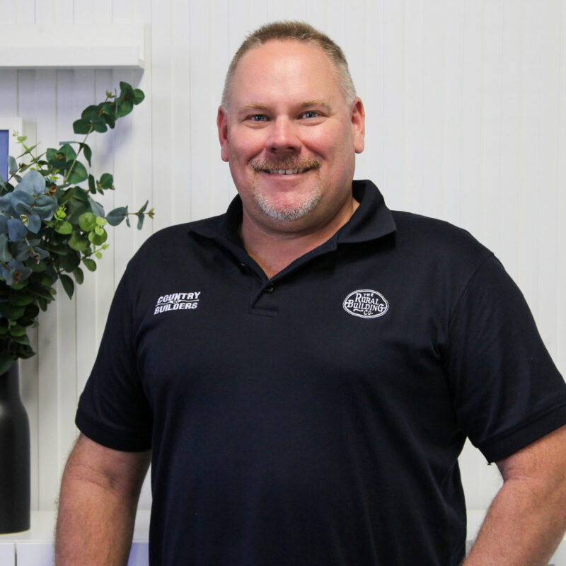 Portrait of a Country Builders team member in a branded polo shirt