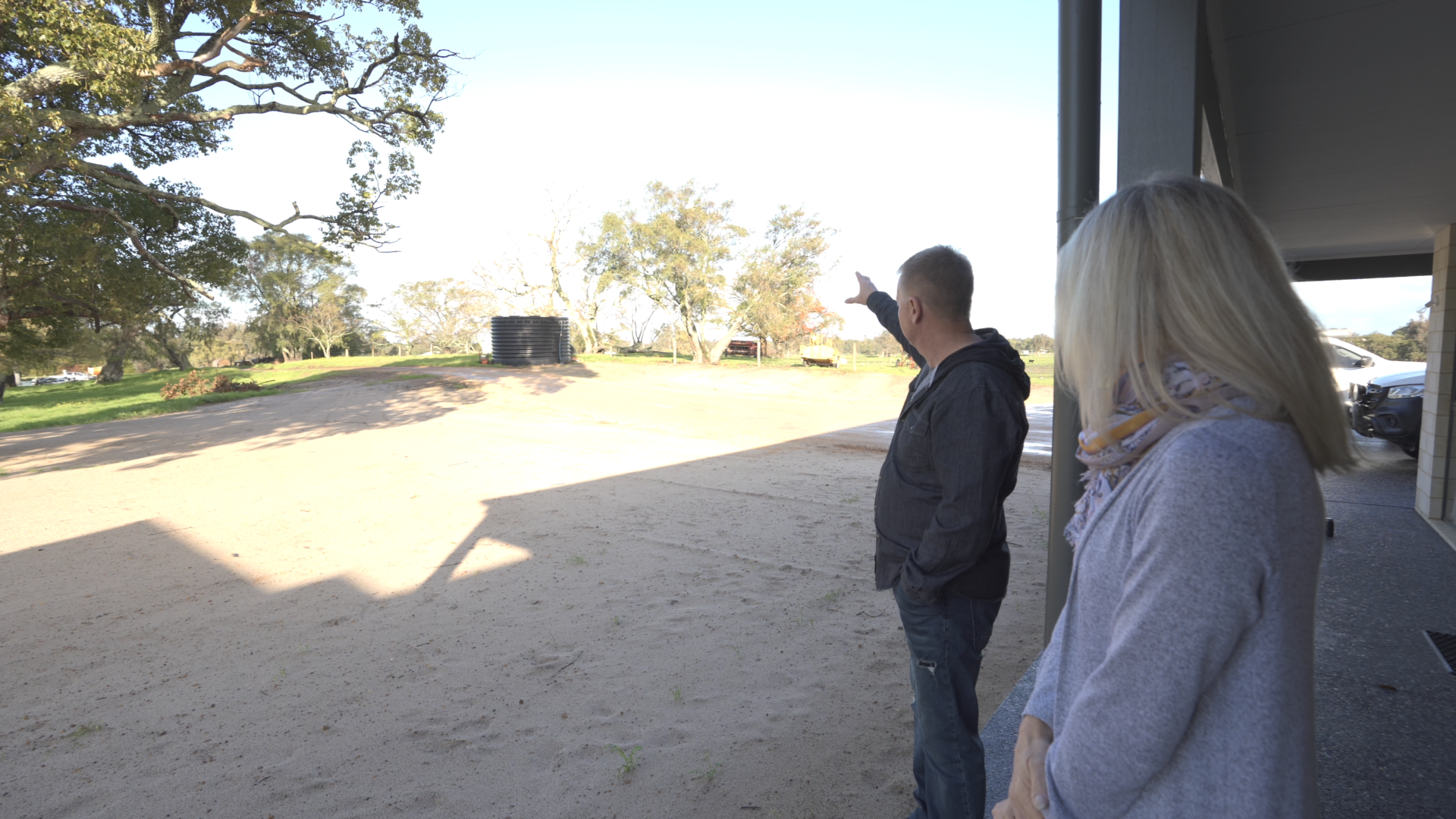 Clients walking a cleared building block with a Rural Building Company team member