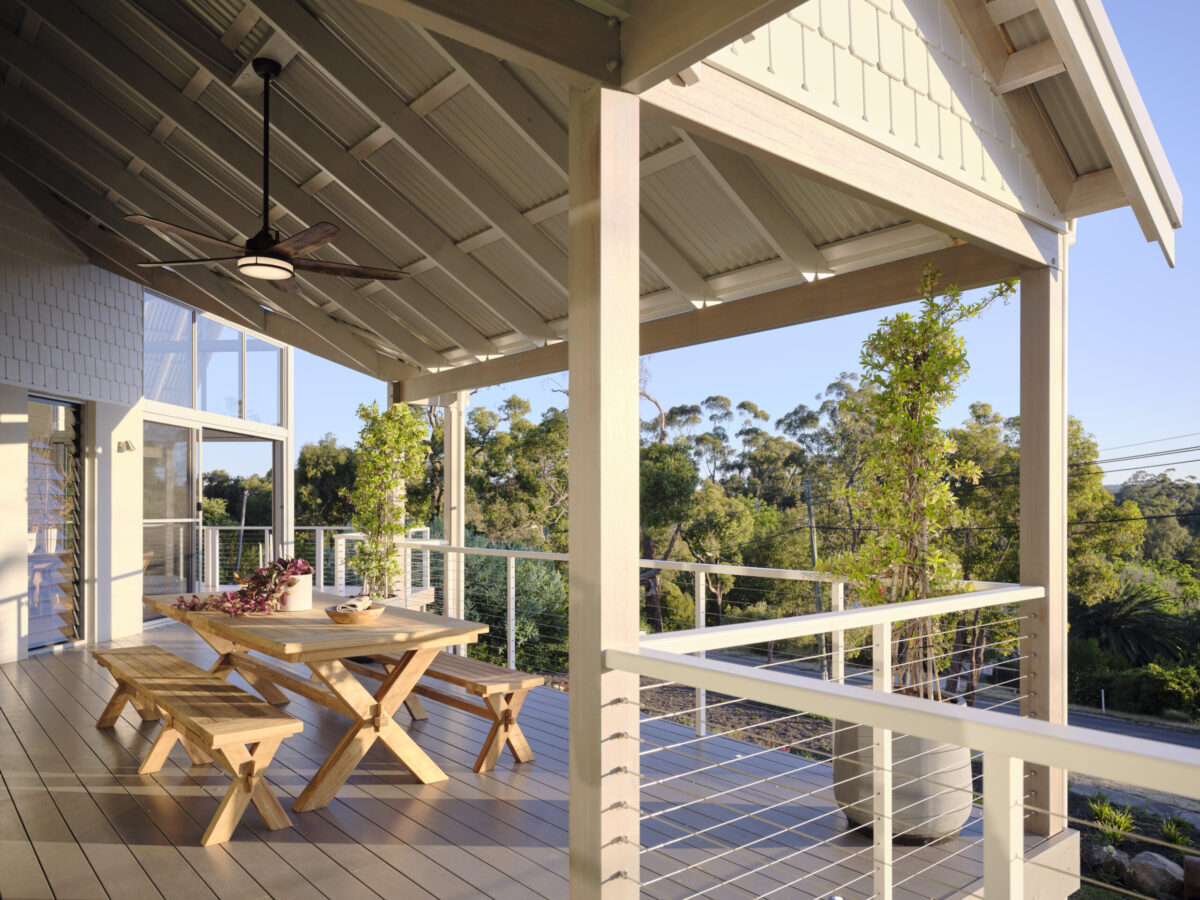 Verandah with timber picnic table and cable balustrade over bushland
