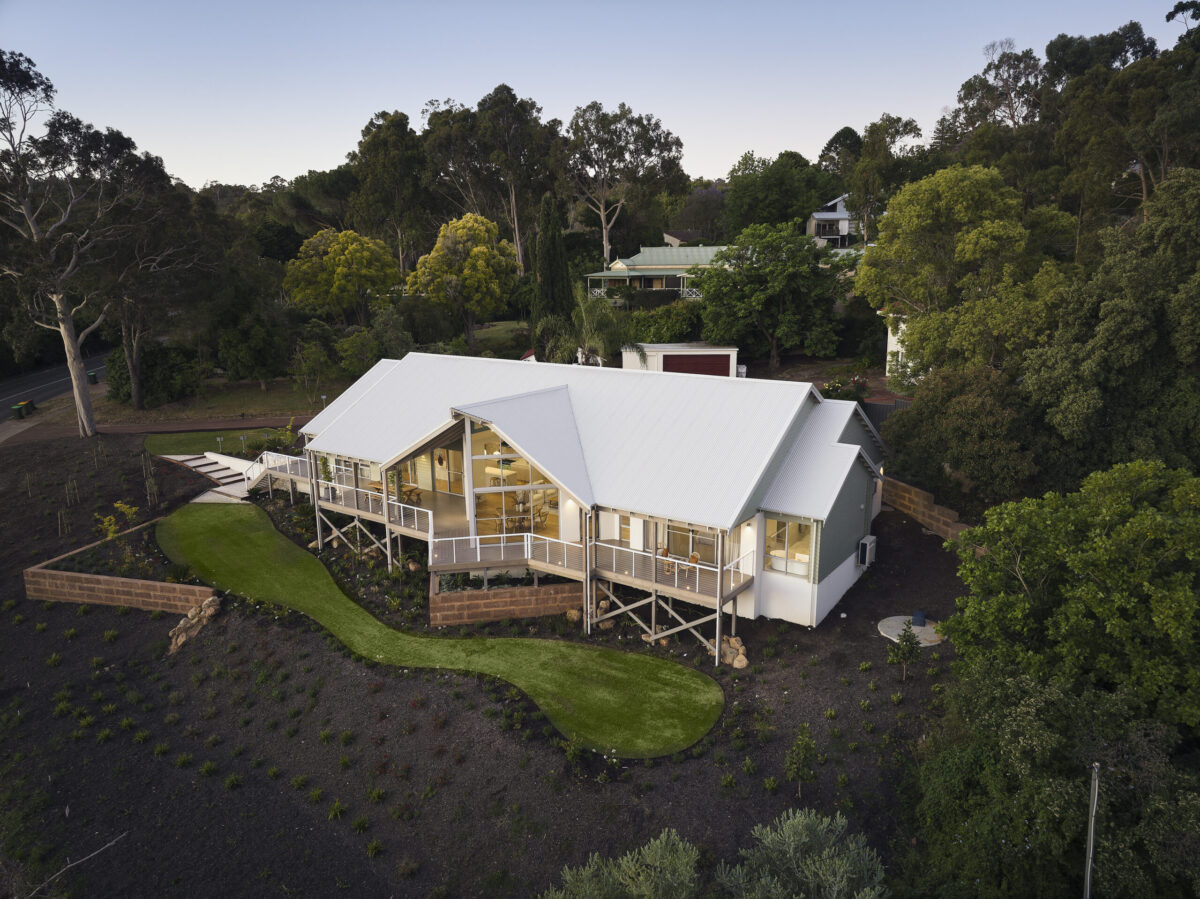 Aerial view of The Darlington display home with gable rooflines and landscaped grounds