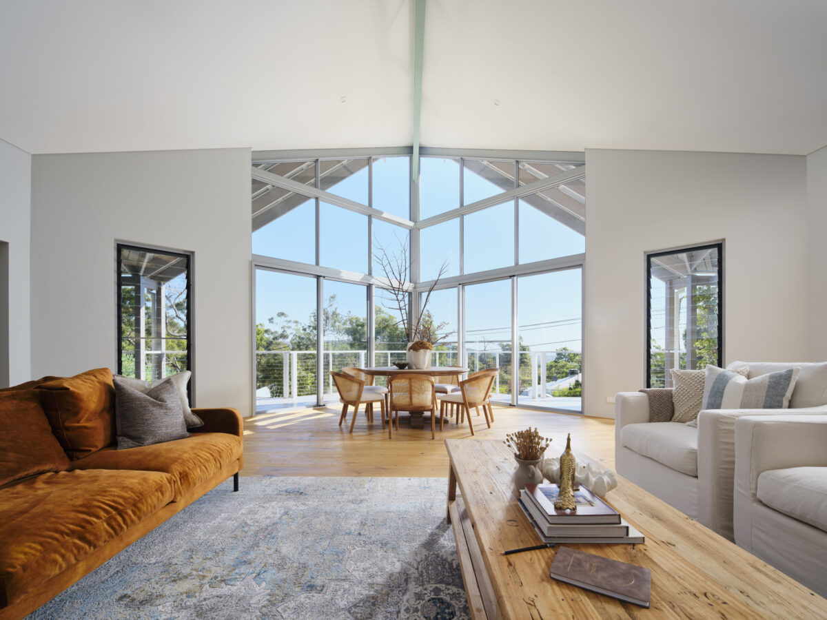 Living area with tan sofa, gable glazing and rural outlook