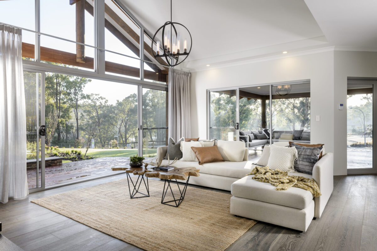 Living area with white sofa, chandelier and glazing to the garden