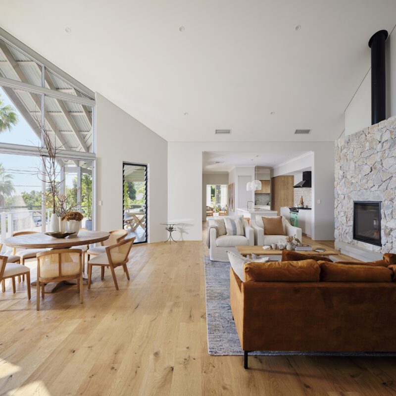 The living and dining area is bathed in natural light from the feature floor to ceiling window - Rural Building Co.