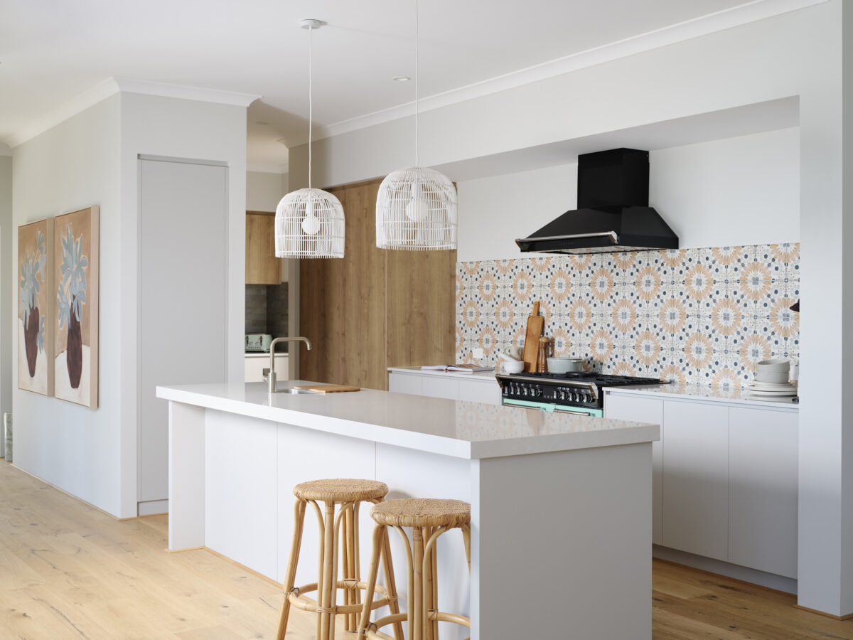 Natural light from tall windows floods into the kitchen in The Darlington display home - Rural Building Co.