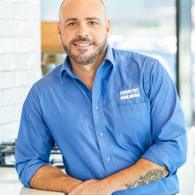 Portrait of a Country Builders team member in a branded polo shirt