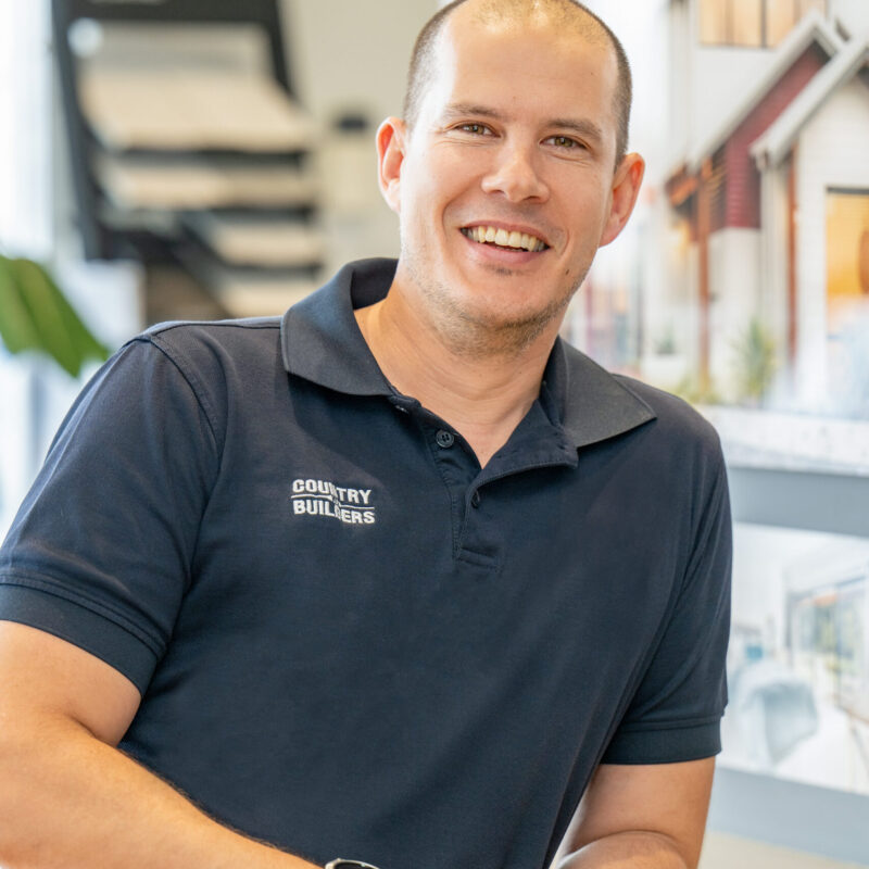 Portrait of a Country Builders team member in a display home showroom