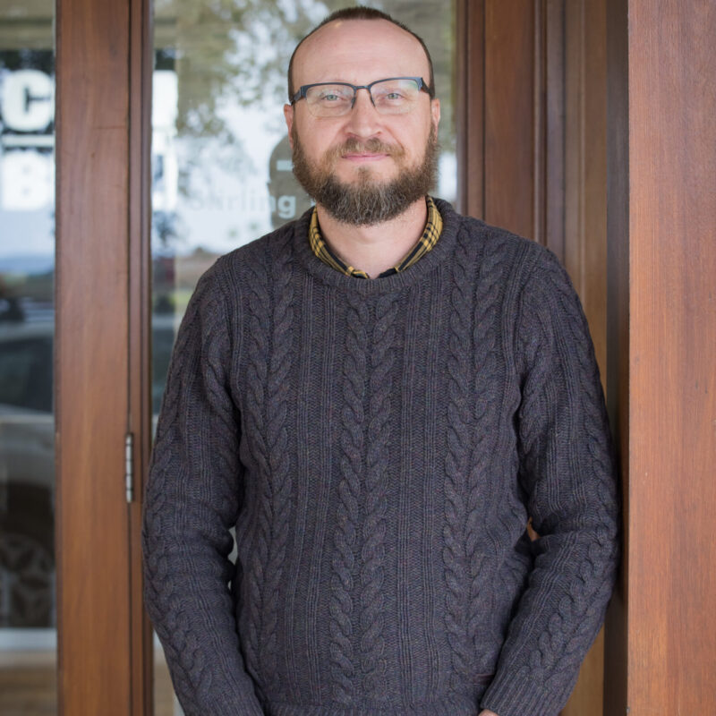 Portrait of a Country Builders team member standing in a doorway