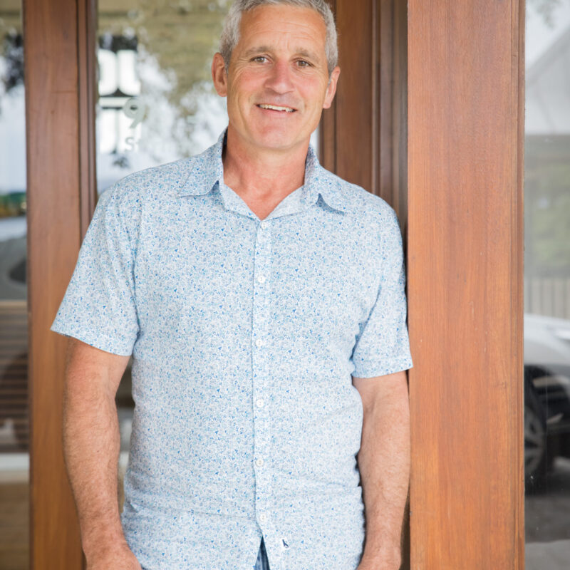 Portrait of a Country Builders team member standing in a doorway