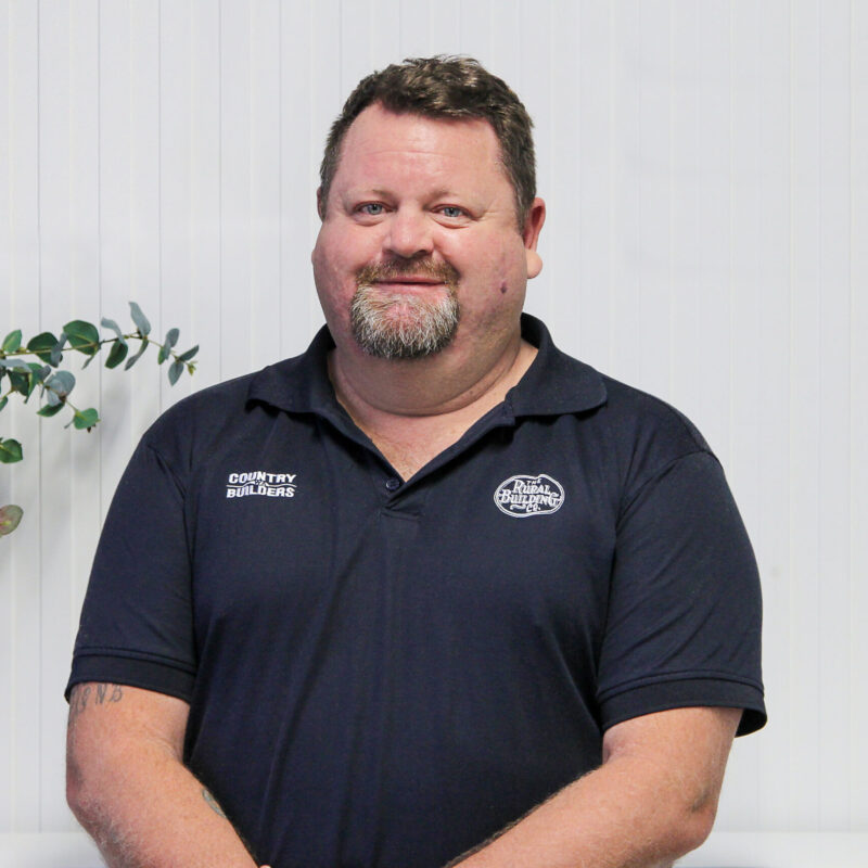 Portrait of a Country Builders site supervisor in a branded polo shirt