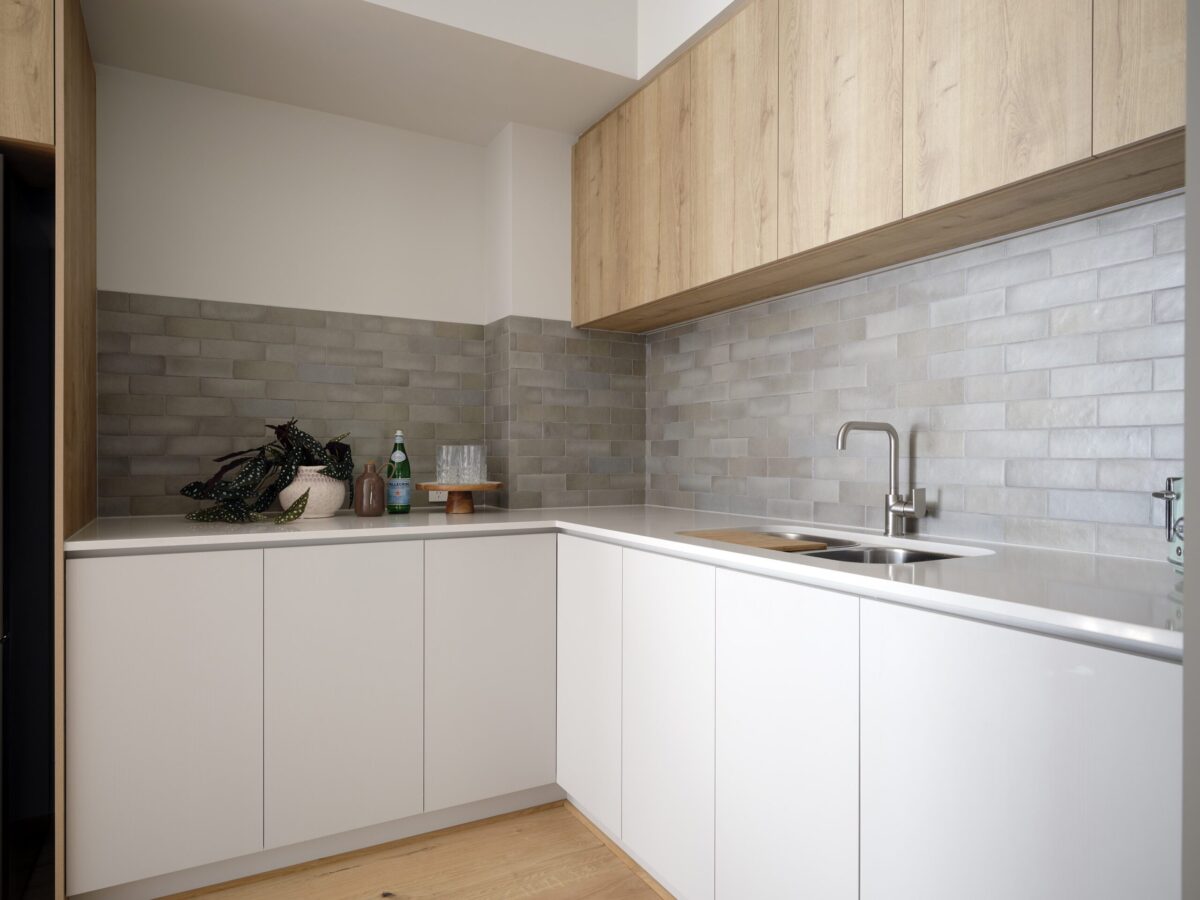 Scullery with white cabinetry, timber overheads and tiled splashback